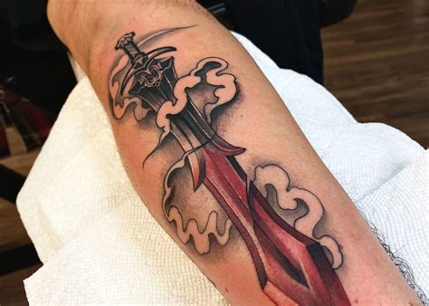 inner forearm sword tattoo|sword and shield tattoo designs.